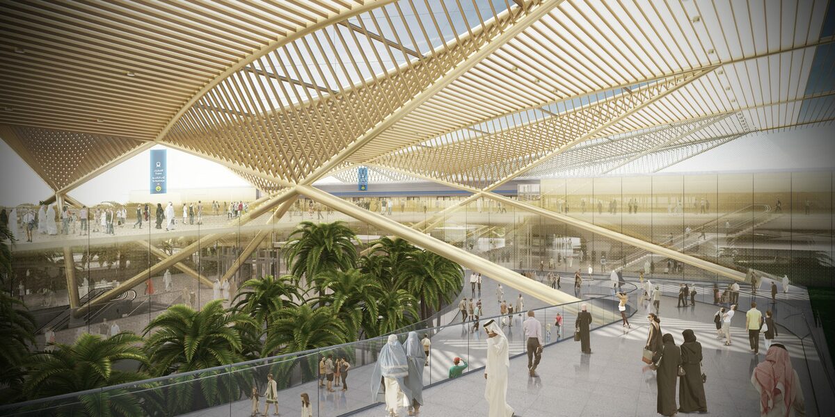 People walking under the curved canopy of an Expolink 2020 metro station.